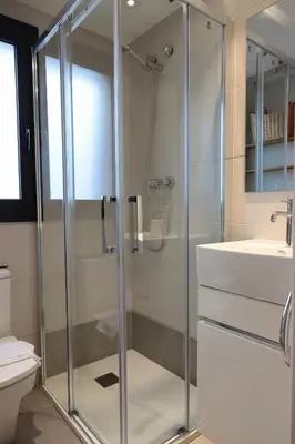 a bathroom with a glass shower and a sink at Winahost La Terraza de Sant Cugat in Sant Cugat del Vallès
