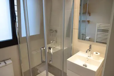 a bathroom with a glass shower and a sink at Winahost La Terraza de Sant Cugat in Sant Cugat del Vallès