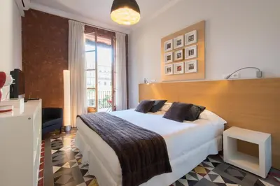a bedroom with a bed and a fireplace and a television at The Collection Barcelona - Paseo de Gracia Catalan 4BD with private Terrace in Barcelona
