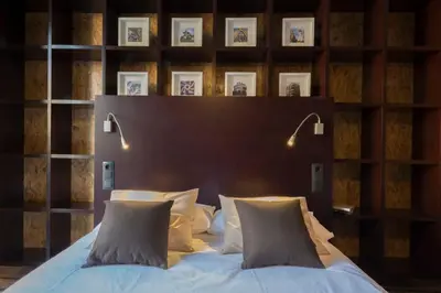 a room with a bed and a table with a coffee cup at The Collection Barcelona - Paseo de Gracia Catalan 4BD with private Terrace in Barcelona