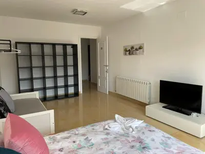 a living room with a flat screen tv on the wall at Habitaciones en Villa Coliving Villa Vistas in San Fausto de Campcentellas