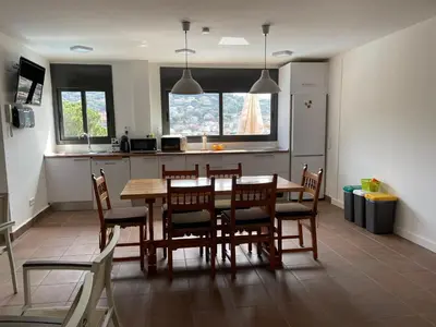a kitchen and dining room with a table and chairs at Habitaciones en Villa Coliving Villa Vistas in San Fausto de Campcentellas