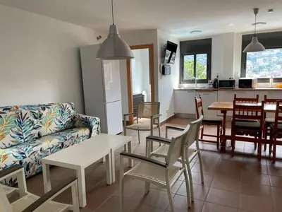 a living room with a couch and a table and chairs at Habitaciones en Villa Coliving Villa Vistas in San Fausto de Campcentellas