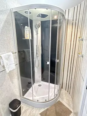 a shower with a glass enclosure in a bathroom at Apartamento Forum in Barcelona