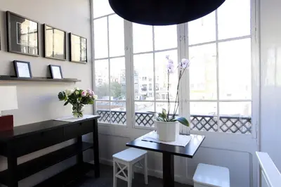 a room with a desk and a window with flowers at Close to Passeig de Gracia in Barcelona