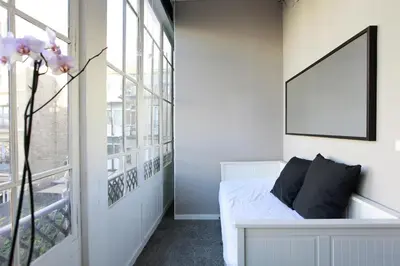 a bedroom with a bed and a large window at Close to Passeig de Gracia in Barcelona
