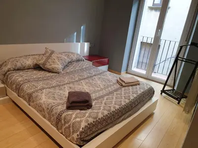 a bedroom with a bed with two towels on it at Pis de bon disseny i sostenible. in Manresa
