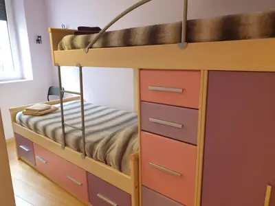a bunk bed with drawers and a bed at Pis de bon disseny i sostenible. in Manresa
