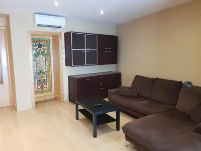 a living room with a couch and a table at Pis de bon disseny i sostenible. in Manresa