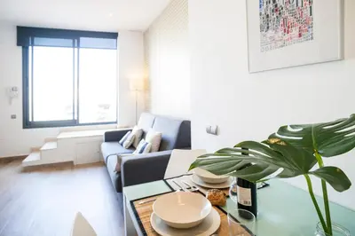a living room with a couch and a table at Feelathome Mozart Apartments in Barcelona