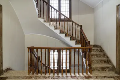 a staircase in a home with white walls and wooden railings at Stay U-nique Apartments Balmes II in Barcelona