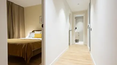 a hallway leading to a bedroom with a bed at Stay U-nique Apartments Balmes II in Barcelona