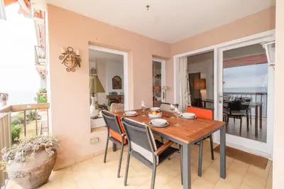 a dining room with a table and chairs at Piso con vista increíble al mar in Sant Andreu de Llavaneres