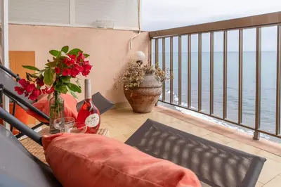 a balcony with a table and a view of the ocean at Piso con vista increíble al mar in Sant Andreu de Llavaneres