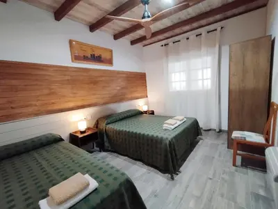a hotel room with two beds and a window at VILLA MasÍa CAL TONI in Pineda de Mar