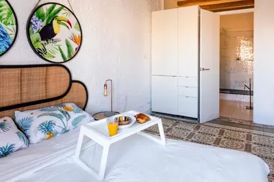 a room with a bed with a tray of food on a table at Enchanting 2 BR flat with terrace near Plaça Espanya in Barcelona