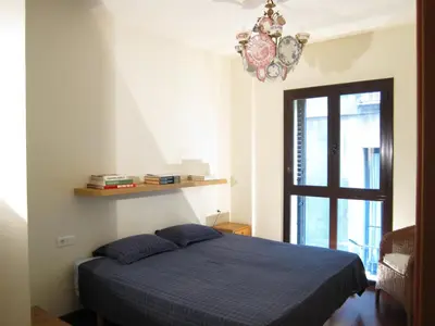 a bedroom with a blue bed and a window at Olles Apartment in Barcelona