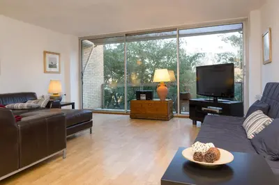 a living room with a couch and a tv at Vila Olimpica Skyline in Barcelona