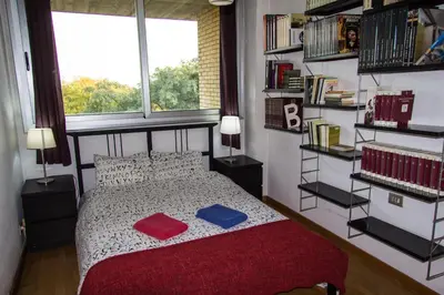 a bedroom with a bed with two pillows and a window at Vila Olimpica Skyline in Barcelona