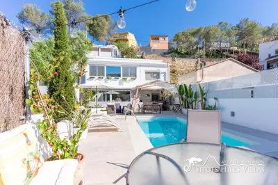 a bedroom with a bed and a view of the ocean at Beautiful Villa Encanto with private pool in Olivella