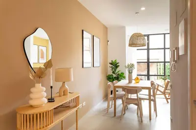 a dining room with a table and a mirror at Lodging Apartments Rambla Poblenou 12 in Barcelona