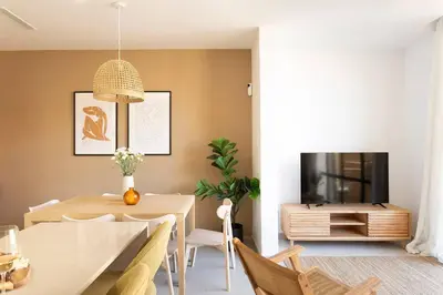 a dining room with a table and a tv at Lodging Apartments Rambla Poblenou 12 in Barcelona