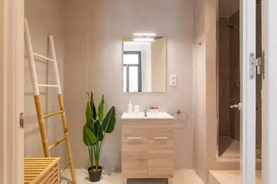 a bathroom with a sink and a mirror at Lodging Apartments Rambla Poblenou 12 in Barcelona