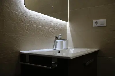 a white sink in a bathroom with a mirror at Apartamento Lauda in Hospitalet de Llobregat
