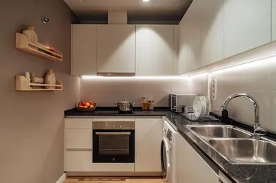 a small kitchen with a sink and a stove at Casa Macaya - 1b apartment in Eixample in Barcelona