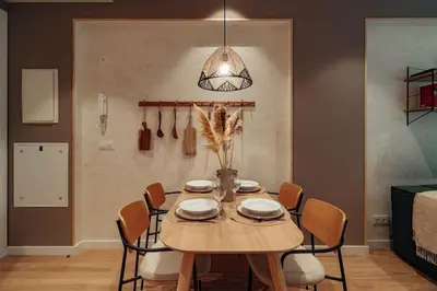 a dining room with a wooden table and chairs at Casa Macaya - 1b apartment in Eixample in Barcelona