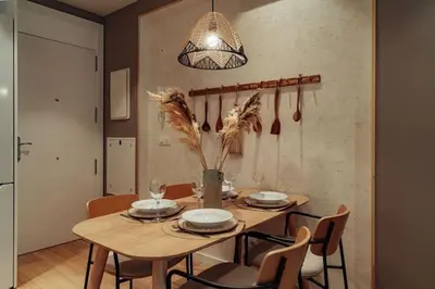 a dining room with a wooden table and chairs at Casa Macaya - 1b apartment in Eixample in Barcelona