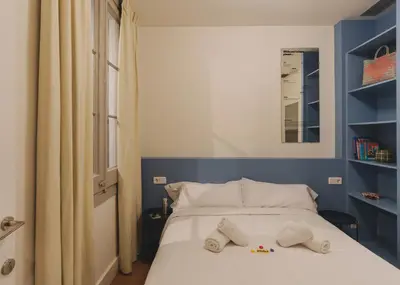 a bedroom with a bed with two pillows on it at Piulet Hostel in Barcelona