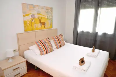 a bedroom with a large white bed with two pillows at Homenfun Barcelona Eixample ll in Barcelona