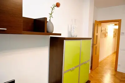 a room with a green cabinet and a hallway at Homenfun Barcelona Eixample ll in Barcelona
