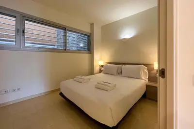 a living room with a blue couch and a table at Stay Unique Apartments Pau Claris con piscina in Barcelona