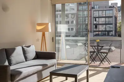 a living room with a couch and a large window at Stay Unique Apartments Pau Claris con piscina in Barcelona