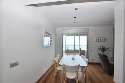 a white dining room with a white table and chairs at Picasso Street in Vilassar de Mar