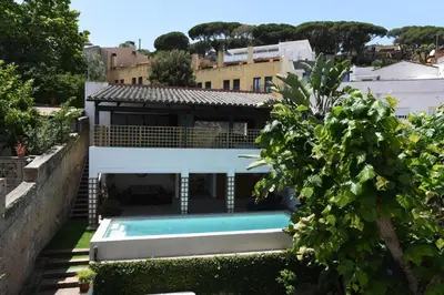 a house with a swimming pool in the yard at Vila d'Alba in Sant Andreu de Llavaneres