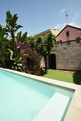 a swimming pool in front of a house at Vila d'Alba in Sant Andreu de Llavaneres