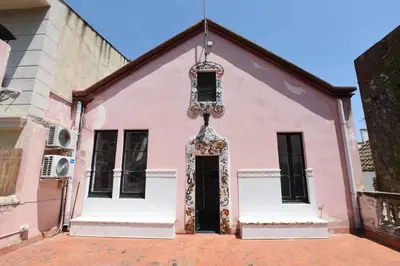 a pink building with a door in the middle at Vila d'Alba in Sant Andreu de Llavaneres