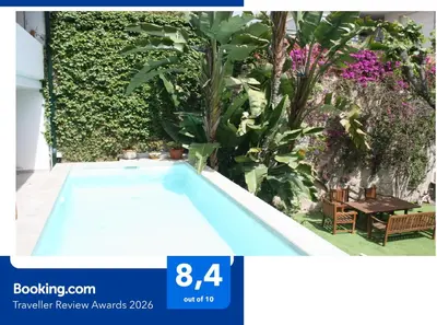 a swimming pool in a garden with plants at Vila d'Alba in Sant Andreu de Llavaneres