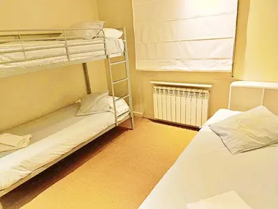 a room with two bunk beds and a window at Preciosa casa al borde de un acantilado in Arenys de Mar