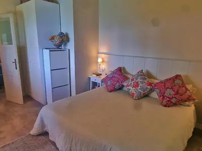 a bedroom with a bed with four pillows on it at Preciosa casa al borde de un acantilado in Arenys de Mar