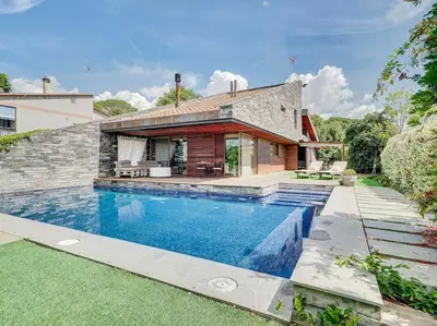 a house with a swimming pool in front of a house at Xauxa in Sant Pere de Vilamajor