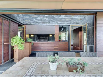 a building with a patio with chairs and plants at Xauxa in Sant Pere de Vilamajor