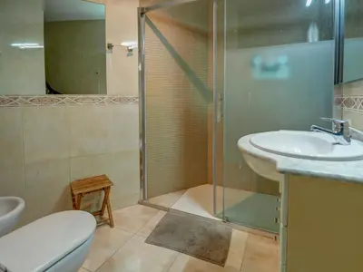 a bathroom with a toilet and a sink and a shower at Castell Apartment by Hello Homes Sitges in Sitges