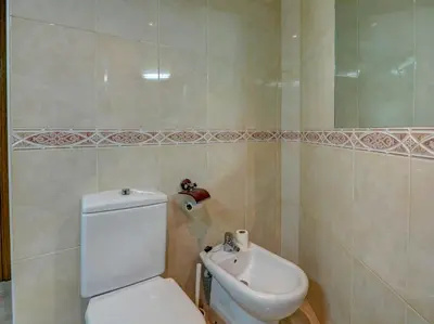 a bathroom with a toilet and a sink at Castell Apartment by Hello Homes Sitges in Sitges