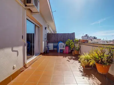 a balcony with a table and chairs on a building at Castell Apartment by Hello Homes Sitges in Sitges