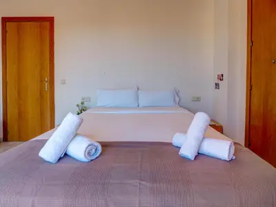 a bedroom with a bed with two towels on it at Castell Apartment by Hello Homes Sitges in Sitges