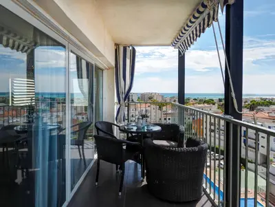 a balcony with a table and chairs and a view at Atalaya Apartment by Hello Homes Sitges in Sitges